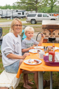 Family eating dinner at campsite